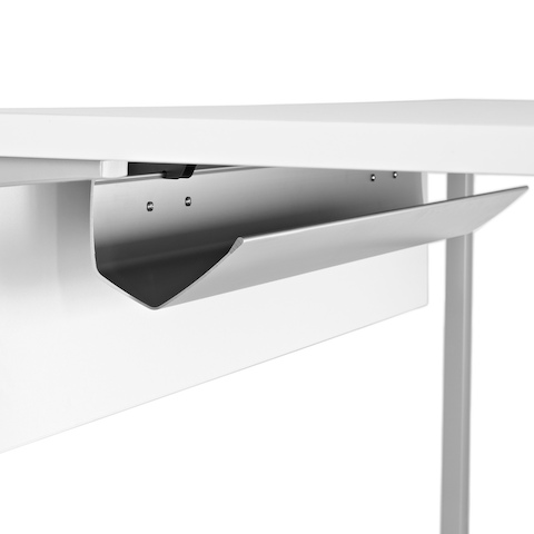 Close-up of a cable trough on the laminate modesty panel attached to the underside of a work surface.