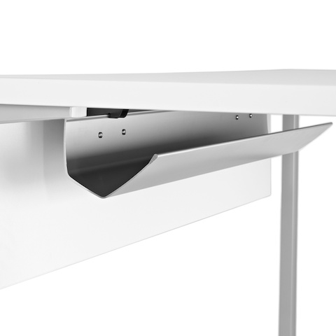 Close-up of a cable trough on the laminate modesty panel attached to the underside of a work surface.