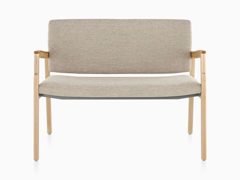 A Monarch Plus chair with an extra-wide seat, beige upholstery, and solid maple frame.