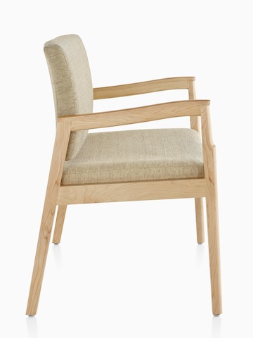 Profile view of a Monarch Plus chair with a wide seat, beige upholstery, memory foam seat, and solid maple frame.