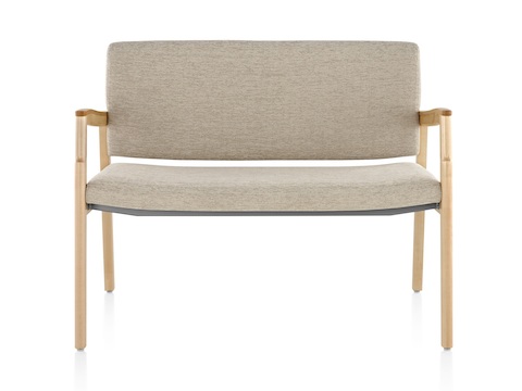 A Monarch Plus chair with an extra-wide seat, beige upholstery, and solid maple frame. A Monarch Plus chair with an extra-wide seat, beige upholstery, and solid maple frame.