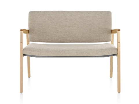 A Monarch Plus chair with an extra-wide seat, beige upholstery, and solid maple frame.