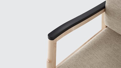 Close-up of a black urethane arm cap and memory foam seat on a beige Monarch Plus chair. Close-up of a black urethane arm cap and memory foam seat on a beige Monarch Plus chair.