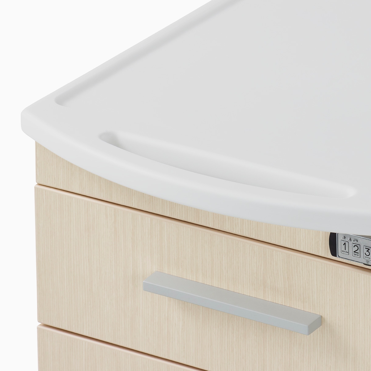 A close-up view of the integrated surface top and pull on a Mora casework supply cart.