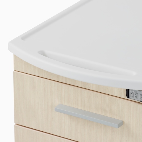 A close-up view of the integrated surface top and pull on a Mora casework supply cart.