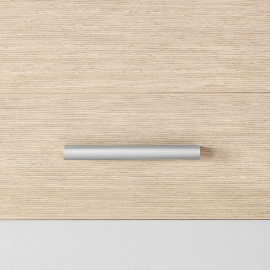 A close-up view of a Mora casework drawer in an ash finish with a profile pull in an silver finish.