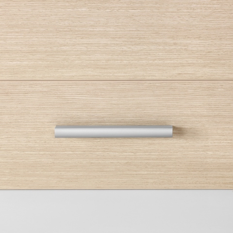 A close-up view of a Mora casework drawer in an ash finish with a profile pull in an silver finish.