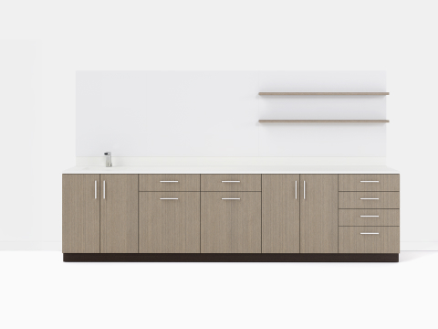 Mora Casework with floating shelves on the wall and multiple base cabinets in a gray teak finish.