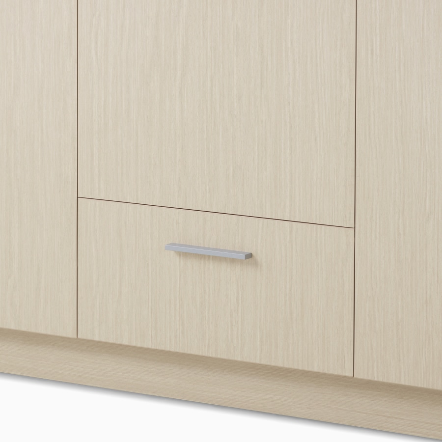 A close-up view of a Mora Casework storage cabinet in a light wood finish.