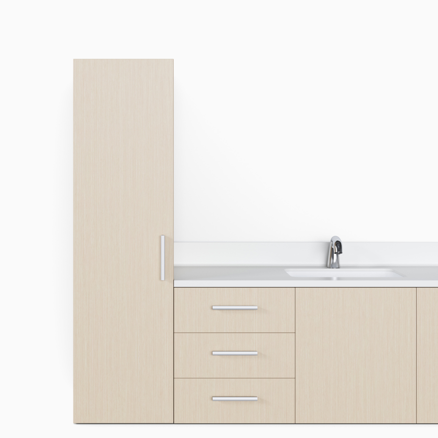 A close-up view of a Mora Casework wall-mounted storage unit with a tall storage tower and drawer storage in an ash wood finish.