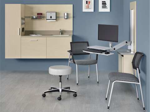 Wall-mounted Mora System casework provides storage, facilitates interaction, and supports technology in a clinical setting. 