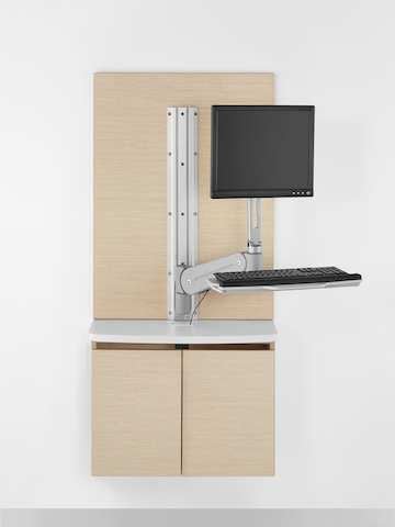 Wall-mounted Mora System clinical casework provides support for a monitor and keyboard.