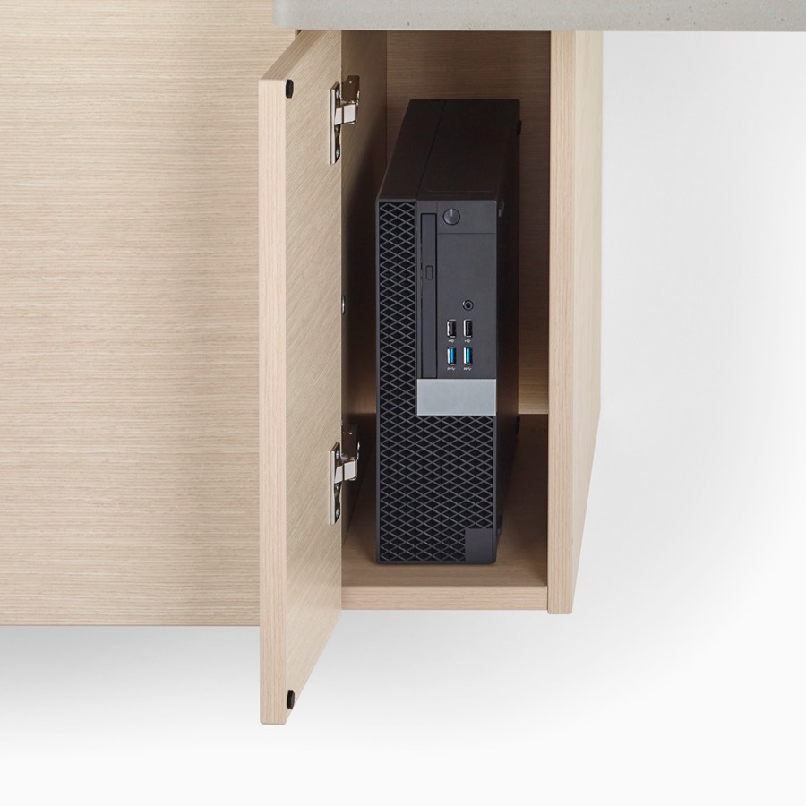A close-up view of a Mora System casework technology storage cabinet in an ash finish holding a black printer.