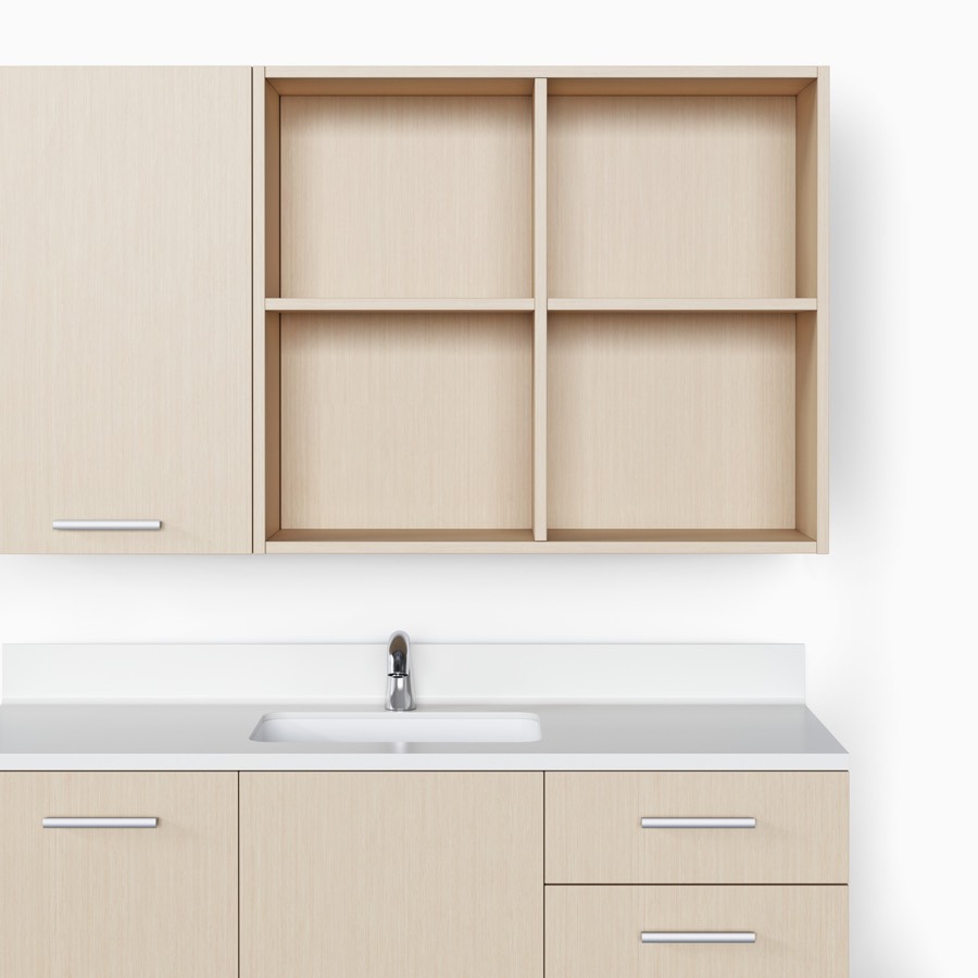 Mora System casework with an open, divided upper storage unit and a lower storage unit in an ash wood finish.