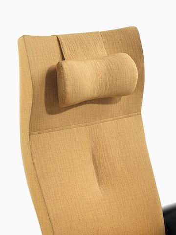 Close view of the upholstered headrest on the back of a mustard-coloured Nala Patient Chair.