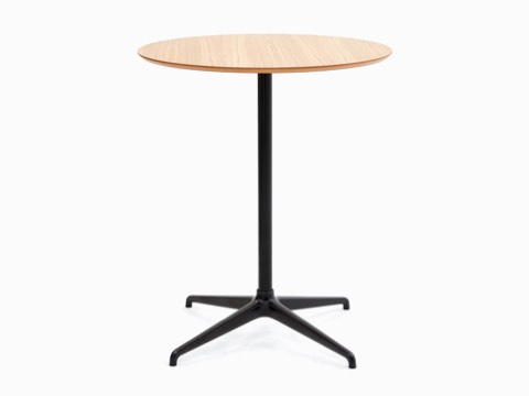 A NaughtOne Ali Bar-Height Table with a black 4-star base and circular oak veneer table top. A NaughtOne Ali Bar-Height Table with a black 4-star base and circular oak veneer table top.
