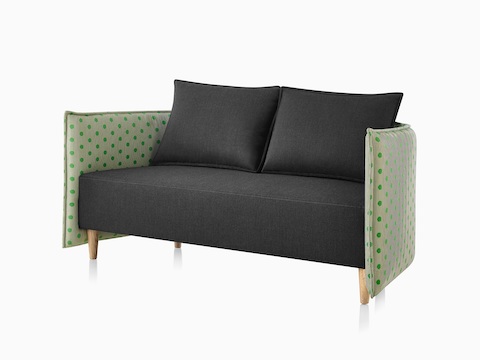 Cloud Plain Low Back Two-Seat Sofa with a dark grey textile, Maharam avocado dot textile, and solid wood legs.