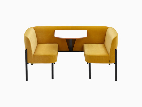 Standard-height Hue Booth, upholstered in yellow velvet with black legs and white table, viewed from the front.