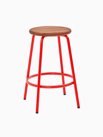 A Penny Stool with a red base and walnut seat.