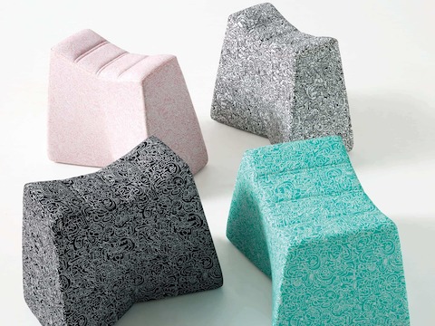Black, pink, gray, and teal Pinch Stools with the same pattern covering each one.