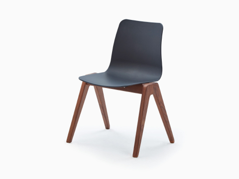 A black NaughtOne Polly Wood Chair with an walnut base, viewed at an angle. A black NaughtOne Polly Wood Chair with an walnut base, viewed at an angle.