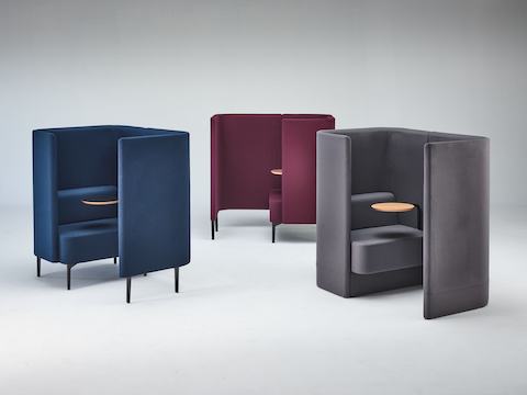 Group shot of two Pullman Chair Pods with legs and one with upholstered plinth base.