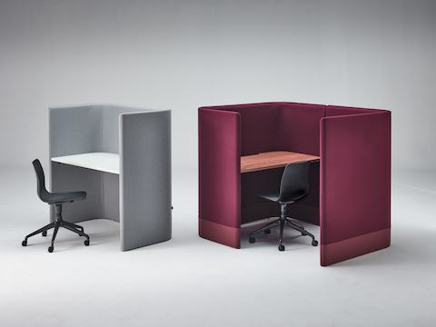 Grey Pullman Desk with black Polly chair, sitting next to burgundy Pullman Desk Pod with Polly chair.