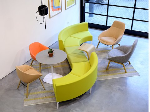 A green Symbol Bench joining two green 90 degree Symbol Modular Seating pieces.
