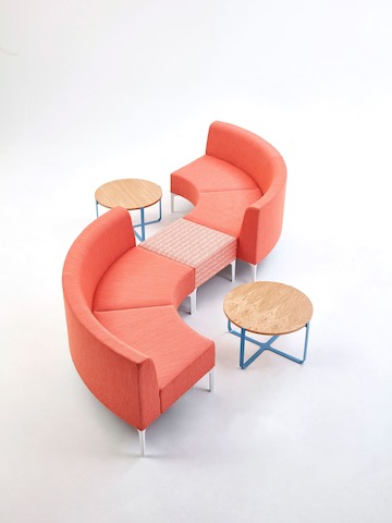 A coral patterned Symbol Single Stool joining two coral Symbol Modular Seating 90-Degree curve pieces.