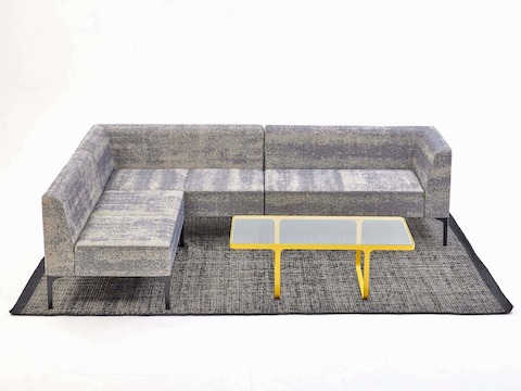 Three grey patterned Symbol Modular seating pieces configured to create an L-shaped seating arrangement.