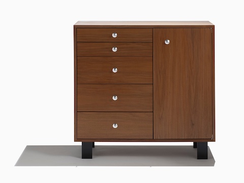 A Nelson Basic Cabinet Series drawer-and-door chest with a medium finish and aluminum knobs.