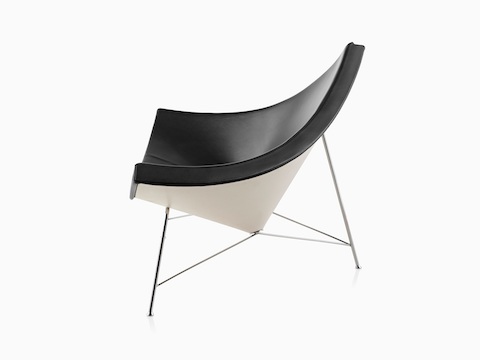 Profile view of a black leather Nelson Coconut Lounge Chair. 