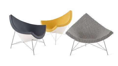 Three Nelson Coconut Lounge chairs arranged in different angles. A dark grey chair faces a yellow chair in opposing 45-degree angles and a black and white checkerboard chair is placed to the right of them facing forward.