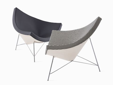 Two Nelson Coconut Lounge chairs facing each other. The left dark grey chair at a 45-degree angle, and the right black and white checkerboard chair is in profile.