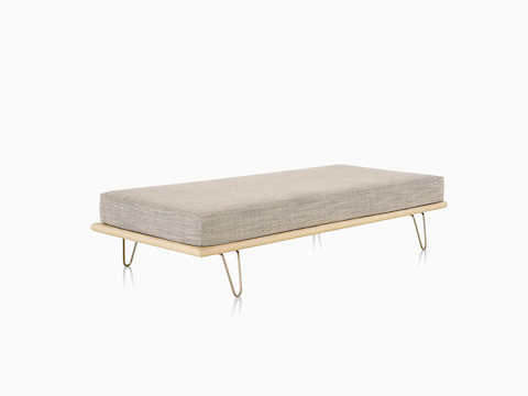A light gray Nelson Daybed in the bed position with the back bolsters removed, viewed from a 45-degree angle. 