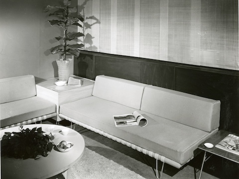 A vintage black-and-white photo of two Nelson Daybeds used as sofas in an office lobby. A vintage black-and-white photo of two Nelson Daybeds used as sofas in an office lobby.