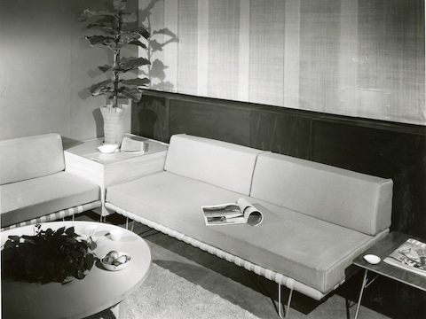 A vintage black-and-white photo of two Nelson Daybeds used as sofas in an office lobby.