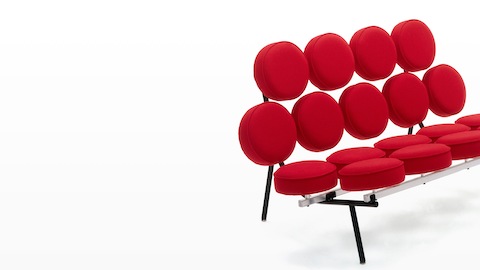 A Nelson Marshmallow Sofa upholstered in red fabric, viewed from a 45-degree angle.
