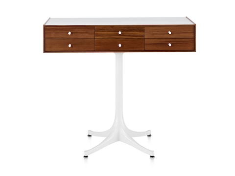 A horizontal six-drawer Nelson Miniature Chest with a medium finish, white top, and white pedestal base. A horizontal six-drawer Nelson Miniature Chest with a medium finish, white top, and white pedestal base.