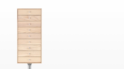 A vertical nine-drawer Nelson Miniature Chest with a light finish and polished aluminum base. 