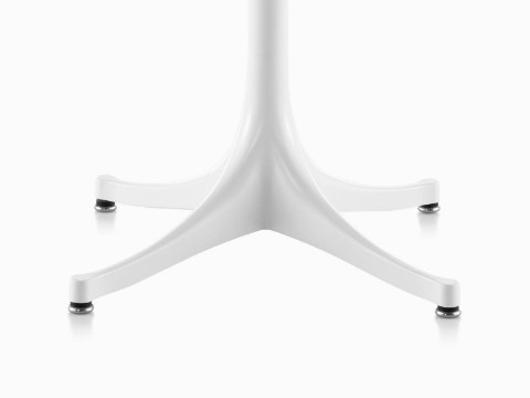 Close view of the Nelson Pedestal outdoor table's distinctive base, shown with a white finish. 