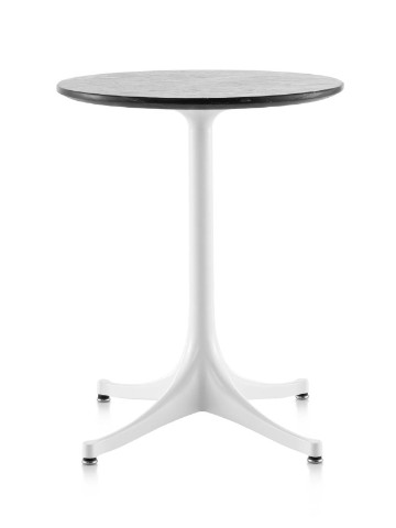 A round Nelson Pedestal outdoor side table with a black stone top and white base. A round Nelson Pedestal outdoor side table with a black stone top and white base.