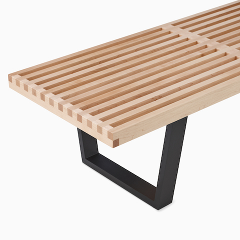 A close-up view of the Nelson Platform Bench wood frame. 