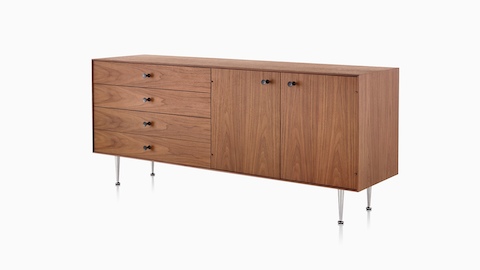 An angled view of a Nelson Thin Edge chest combining four drawers and two cabinets in a medium finish.