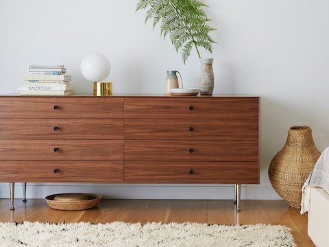 Um Nelson Thin Edge cômoda dupla com oito gavetas, botões pretos e um acabamento médio em um ambiente residencial. Um Nelson Thin Edge cômoda dupla com oito gavetas, botões pretos e um acabamento médio em um ambiente residencial.