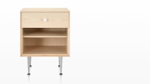 A Nelson Thin Edge bedside table with a light finish, white knob, and slim aluminum legs. A Nelson Thin Edge bedside table with a light finish, white knob, and slim aluminum legs.