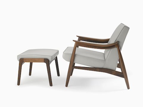 An Aspen Lounge Chair and Ottoman in a gray textile with walnut base and arms.