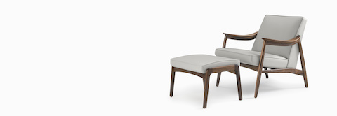 An Aspen Lounge Chair and Ottoman in a gray textile with walnut base and arms.