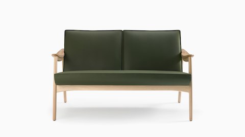 An Aspen lounge settee in green textile with maple base and arms.