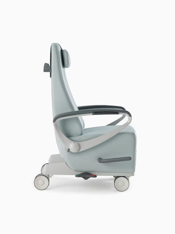 Nemschoff Ava Recliner with arcade back in a light blue upholstery with a headrest, viewed from the side.